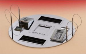 Circular metal device with screens and slots.